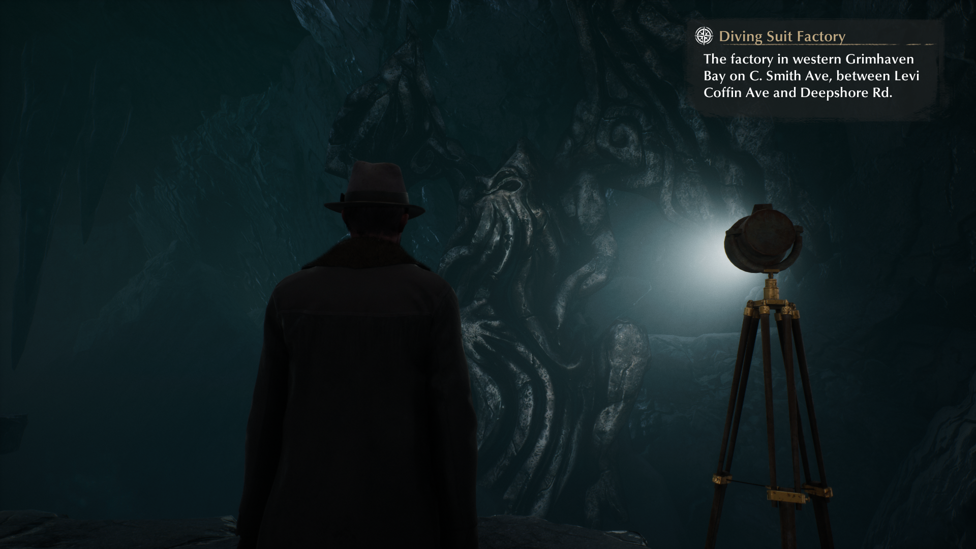 Reed looking at a Cthulhu statue inside an excavation